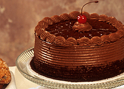 Photo: A chocolate cake on a glass cake stand. Link to photo information.