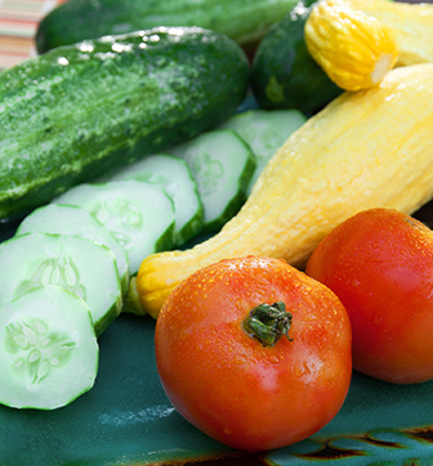 Sliced cucumbers, yellow squash and tomatoes.
